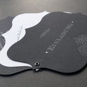 Formschöne Letterpress Einladungskarten zum Geburtstag in schwarz und weiß gehalten, wo die Einladungskarte aus mehreren ausgestanzten Letterpresskarten zusammengeöst wurde